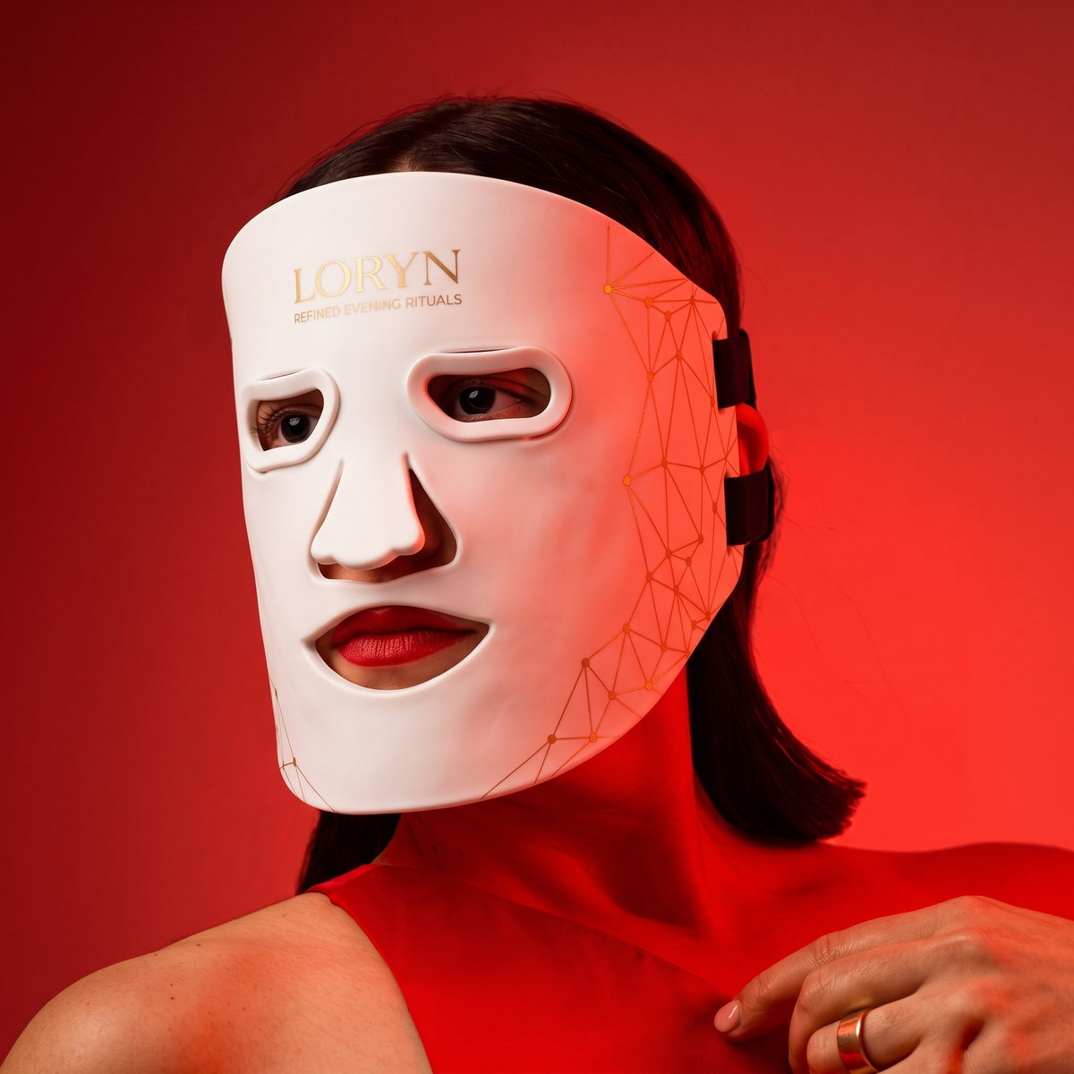 Woman wearing red light therapy mask at home