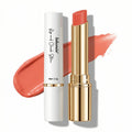 Lipstick with gold cap and white casing on a white background