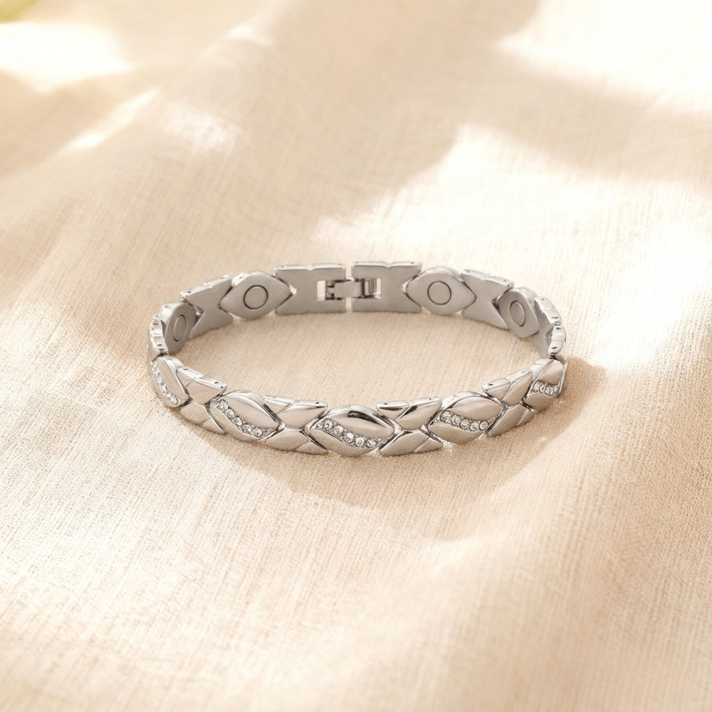 Silver bracelet with braided design on a beige fabric background